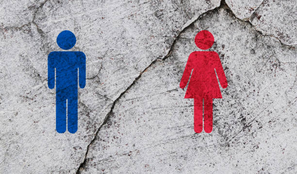 Broken brick wall with man and woman symbols