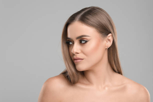 istock Beautiful woman with makeup on grey background, space for text 1831875409
