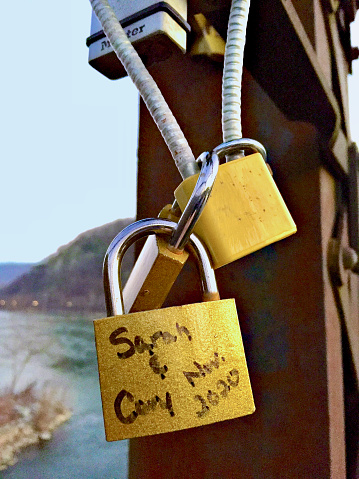 Harpers Ferry, West Virginia, USA - December 12, 2020: “Love Locks”along the Goodloe E. Byron Memorial Pedestrian Walkway are attached to a railroad bridge over the Potomac River.