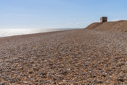 The pebble beach and the bird hide in Dungeness, Kent, England, UK