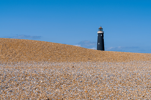 The beach and the Old Lighthouse in Dungeness, Kent, England, UK