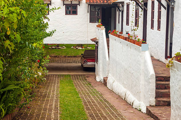 Old Car and Colonial Houses Old red classic car next to white colonial style houses driveway colonial style house residential structure stock pictures, royalty-free photos & images