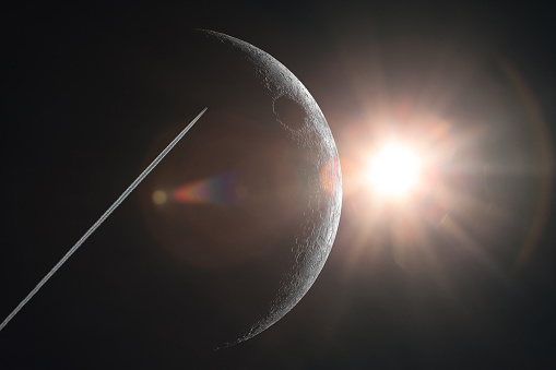 Space photo with the image of the moon, the sun and the trail of a flying rocket. Cosmos, the rocket flies to the moon. The image is based on a photograph of the moon taken through a telescope by the author.