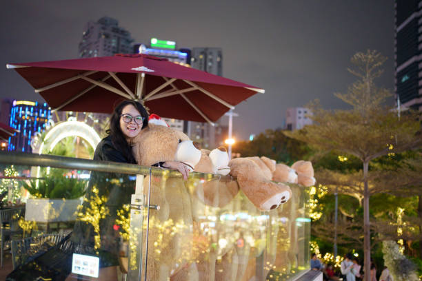 Bear doll and Asian woman