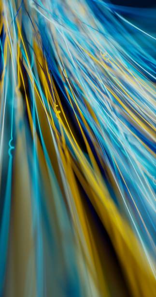 istock Narrow threads of light extend through the depths of darkness. 1831909086