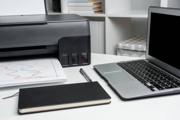 istock New modern printer and laptop in the office on table 1831918844