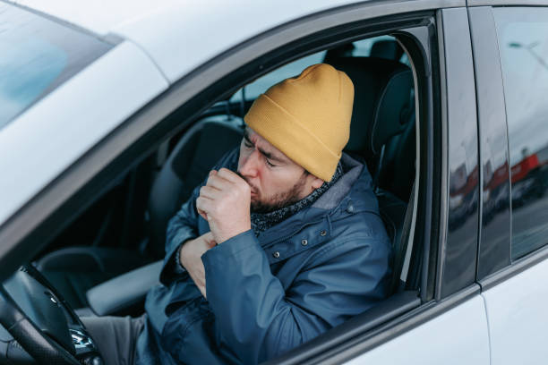 istock Drive Through Sickness Bearded Chauffeur Coughs in Seasonal Ailment 1831924631