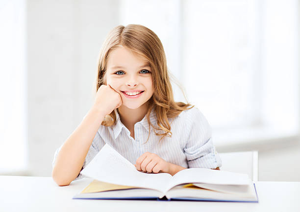 istock little student girl studying at school 183193631