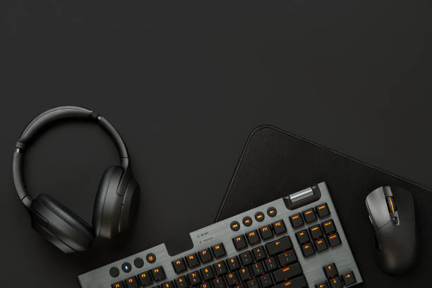 istock Headphones, computer mouse and keyboard on black background 1831947119
