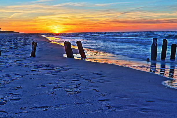 istock Sunset at the beach and breakwater 183194848