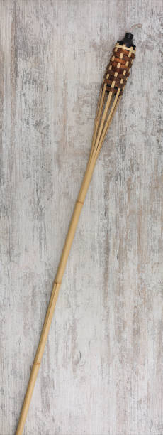 istock bamboo torch on wooden background 1831952300