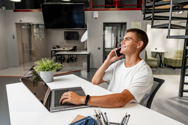 istock Handsome businessman using smartphone in the office, portrait 1831978152