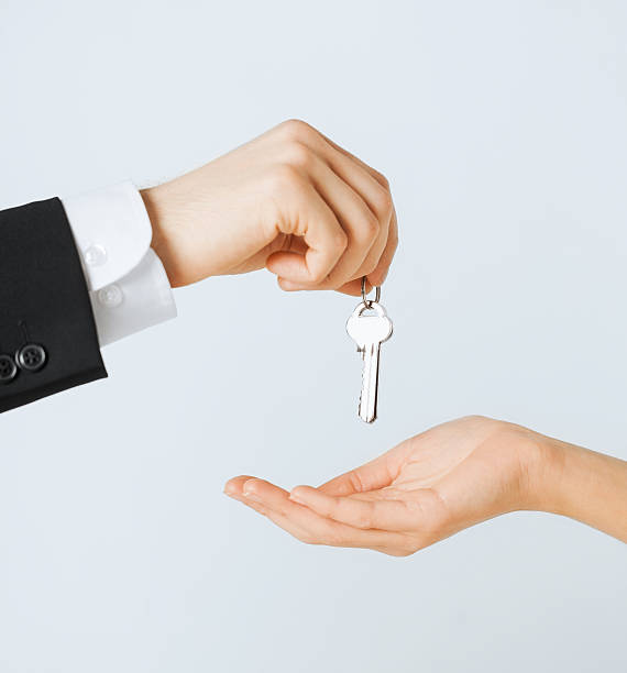 istock man and woman with house keys 183199576