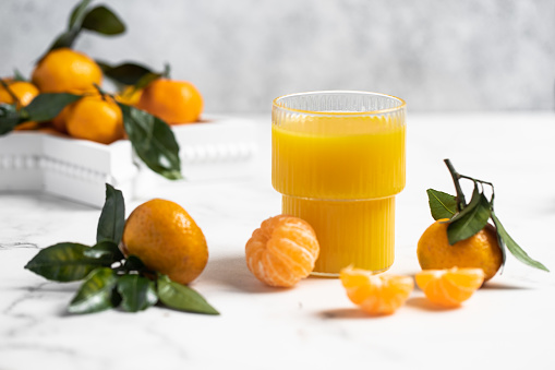 freshly squeezed refreshing orange juice, tangerines with leaves