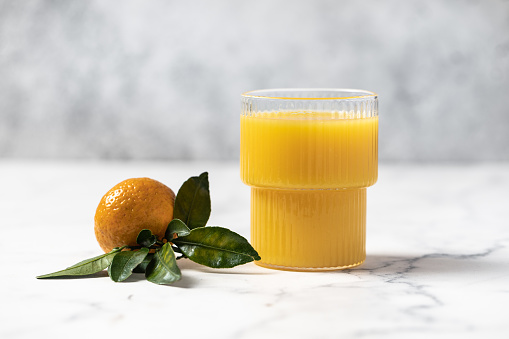 freshly squeezed refreshing orange juice, tangerines with leaves