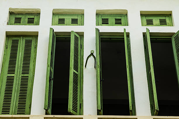 Green vintage wooden windows, colonial style building from Vient stock photo