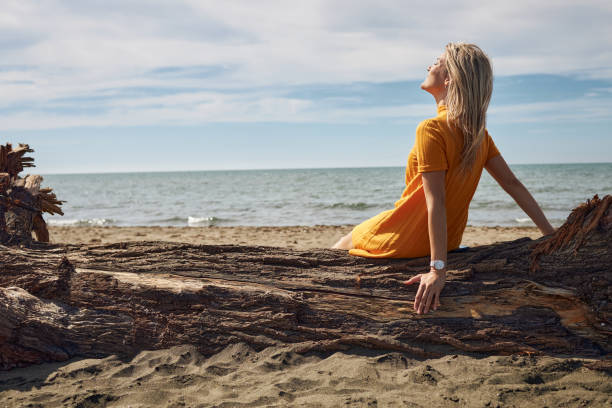 istock Happy woman enjoying day on a beach 1832034505