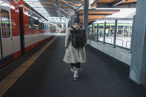 istock Women waits for a train to arrive along a subway platform 1832034645
