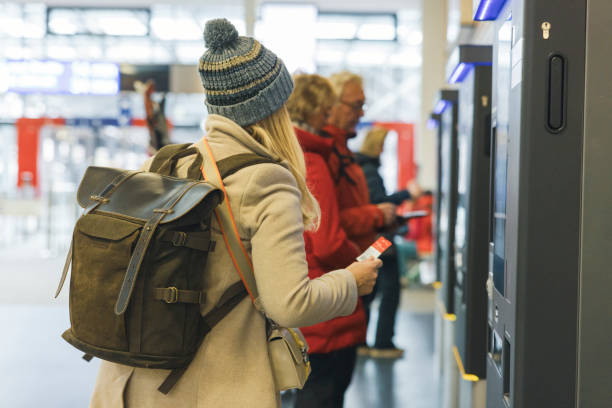 istock Woman buying a train ticket from a ticket machine 1832034651