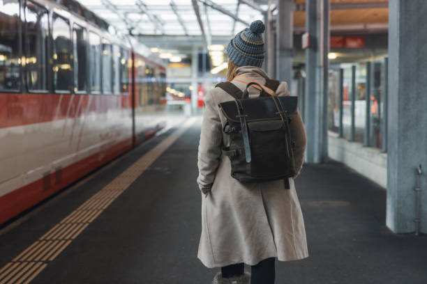 istock Women waits for a train to arrive along a subway platform 1832034652
