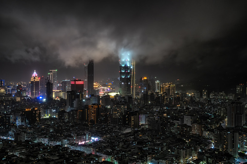 Panoramic view over Taipei 101 and surrounding buildings at night during a rain storm. Famous iconic skyscraper in Taiwan.