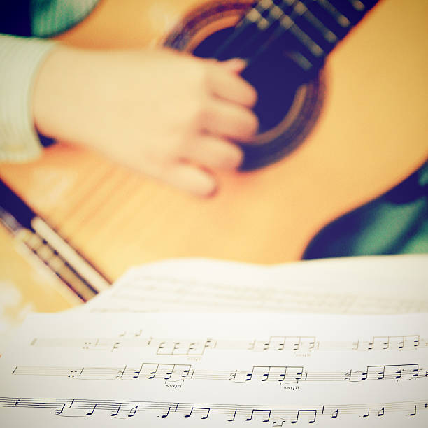 istock Musician playing classical guitar with musical chords 183204541