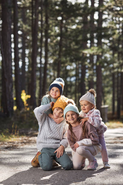 istock Happy children enjoying autumn in forest 1832053859