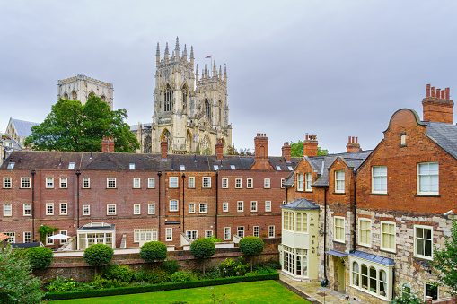 View of old brick buildings, and the York Minster (Cathedral and Metropolitical Church of Saint Peter), in York, North Yorkshire, England, UK