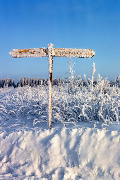 istock Frosty road sign by a snowdrift on a cold winter day 1832054922