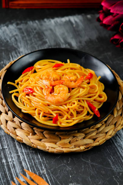 istock spaghetti with shrimp topping on a black plate 1832061115