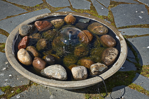 Small water fountain at the river Skellefteälven in Skelleftea, Sweden, Europe