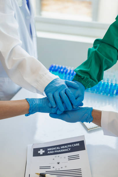 istock Surgeons join together after work to help patients in hospital operating room, emergency, surgery, medical technology Join together to cheer and celebrate post-surgery success and help patients. 1832077954