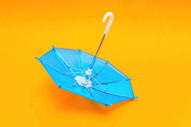 istock Overturned Toy Umbrella Isolated on Yellow Background 1832086292
