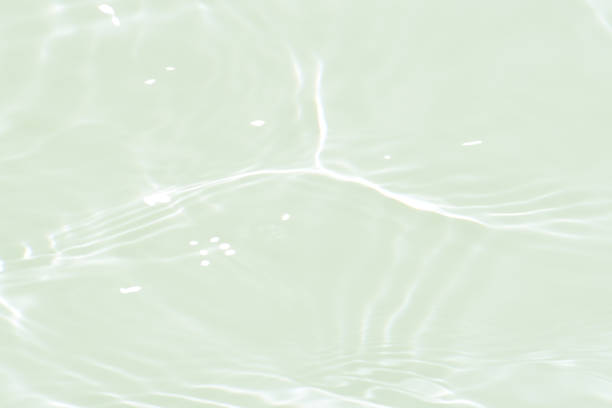 istock White water with ripples on the surface. Defocus blurred transparent white colored clear calm water surface texture with splashes and bubbles. Water waves with shining pattern texture background. 1832101037