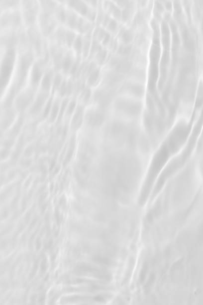 istock White water with ripples on the surface. Defocus blurred transparent white colored clear calm water surface texture with splashes and bubbles. Water waves with shining pattern texture background. 1832101042