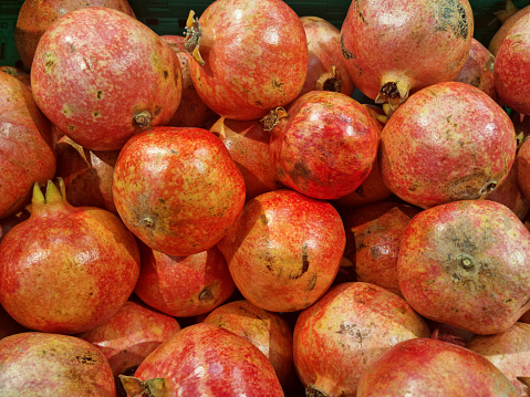 Fresh red juicy pomegranate at street market