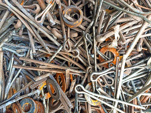 Pile of cotter pin and rusty plate ring, background