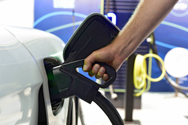 istock Connecting the electric car charging connector 1832124356
