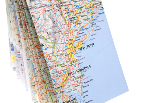 Ready for you next travel-Folded road map isolated on white with New York City and  Philadelphia  visible.