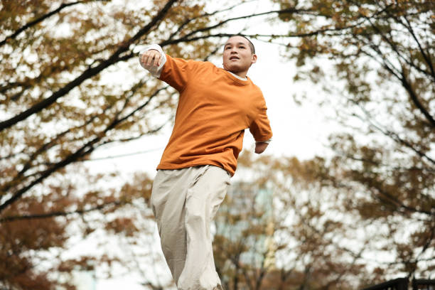Asian individuals living their life to the fullest, by pursuing their hobbies, passions, and dreams.  Young man who has one arm enjoying their hobbies with a positive, focused and joyful expressions