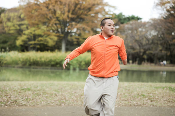 Asian individuals living their life to the fullest, by pursuing their hobbies, passions, and dreams.  Young man who has one arm enjoying their hobbies with a positive, focused and joyful expressions