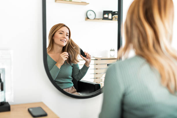 istock Young Woman Grinning While Getting Her Hair Combed 1832140668