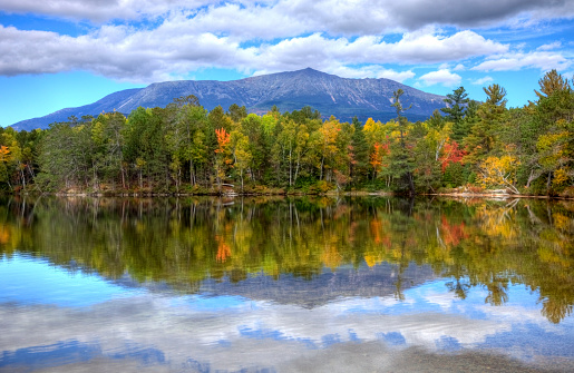 Mount Katahdin is the highest mountain in Maine. Katahdin is the centerpiece of Baxter State Park: a steep, tall mountain formed from underground magma. Photo taken during the fall foliage season. Maine fall foliage ranks with the best in New England bringing out some of  the most beautiful foliage in the United States