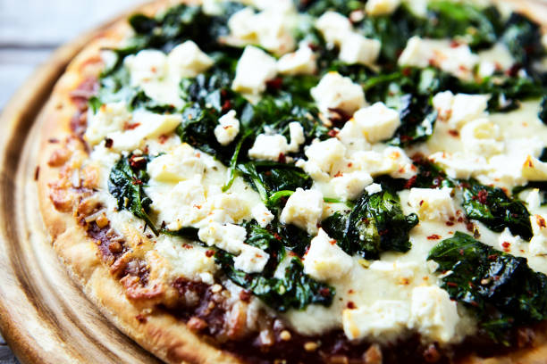 istock Pizza with mozzarella cheese and spinach. Dark wooden background. Close up. 1832176321
