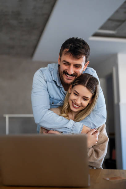istock Young happy couple having video call online, conversation with relatives, communicating with friends 1832177060