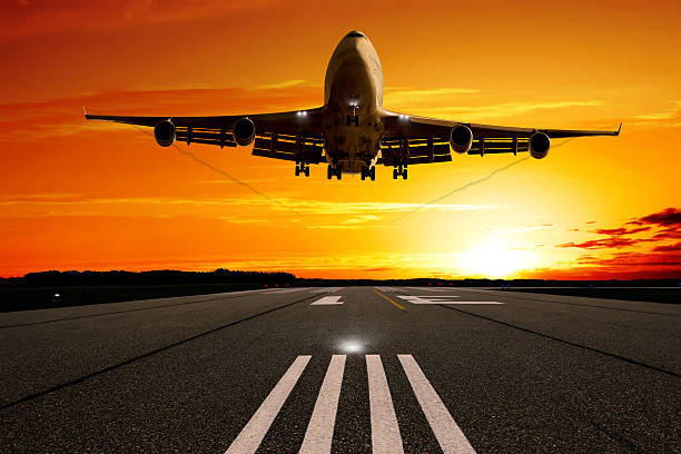 istock XL jumbo jet airplane landing at sunset 183218268