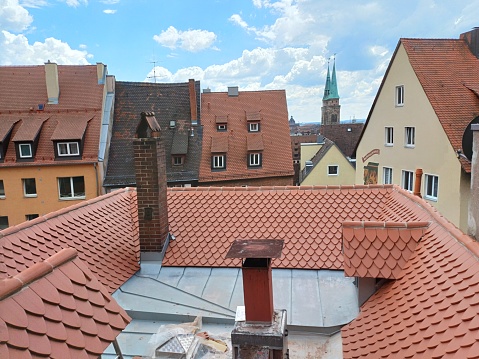 Nuremberg, Germany - June 10, 2023: Red tile roof, windows and chimney of houses at Old town of Nuremberg city, Bavaria, Germany.