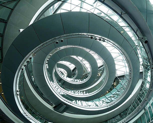 Modern Architecture "Looking up at a spiral shaped office building in London, England.See more spiral staircase images here:" gla building stock pictures, royalty-free photos & images