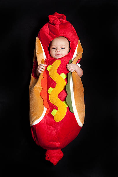 baby in einem hot dog kostüm - wearing hot dog costume stock-fotos und bilder