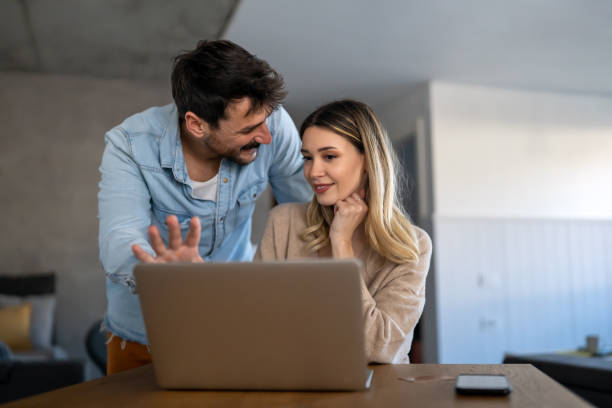 istock Multiethnic colleagues discussing project while working with laptop in office indoors 1832196357